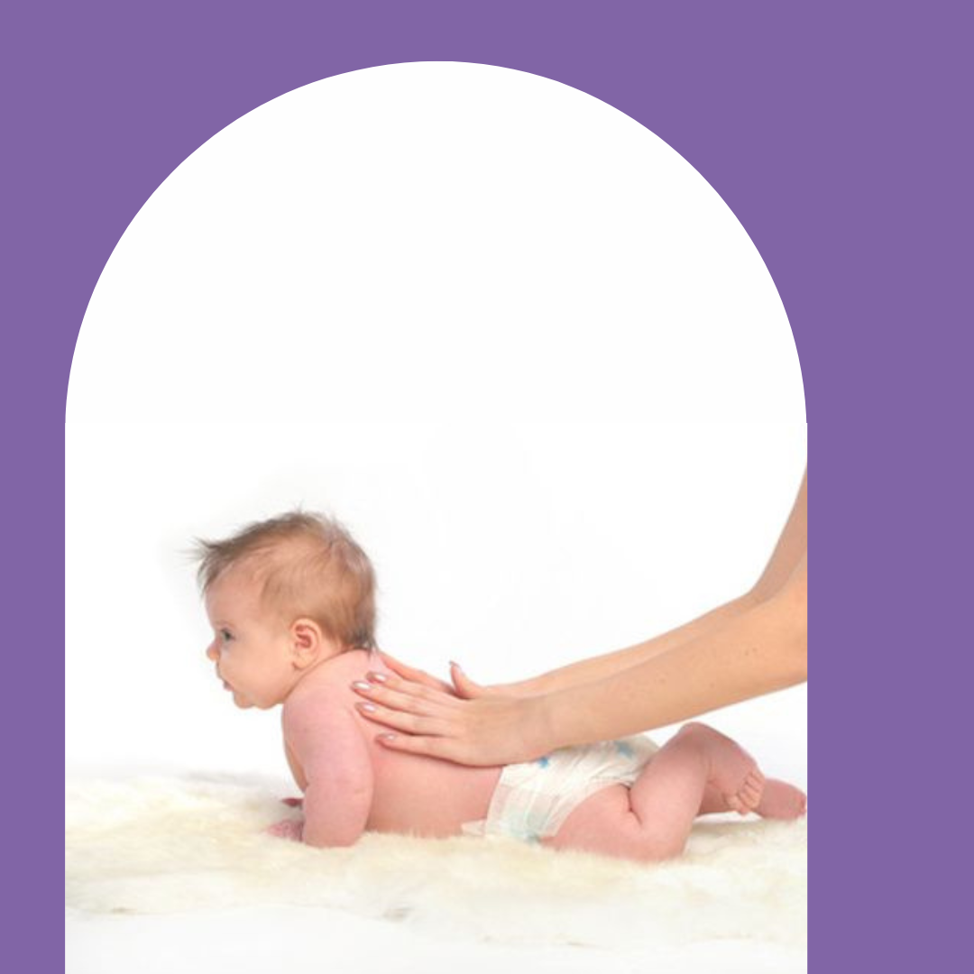 a photo of a baby in a nappy lying on its front. There are two hands massaging its back.